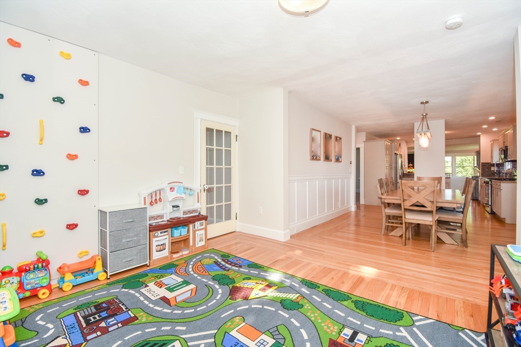 72 Evans Street, Unit 72 Watertown, MA 02472 - Photo 14 of 34 a bedroom with baby bed and a wooden floor