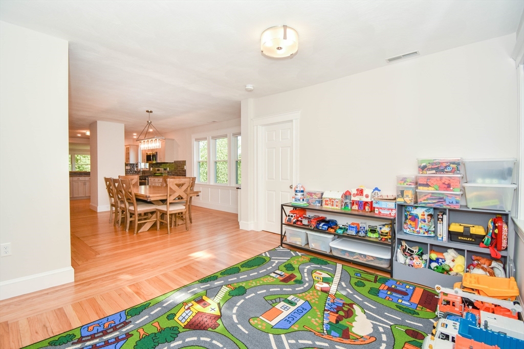 72 Evans Street, Unit 72 Watertown, MA 02472 - Photo 16 of 34 a living room with furniture and a baby crib