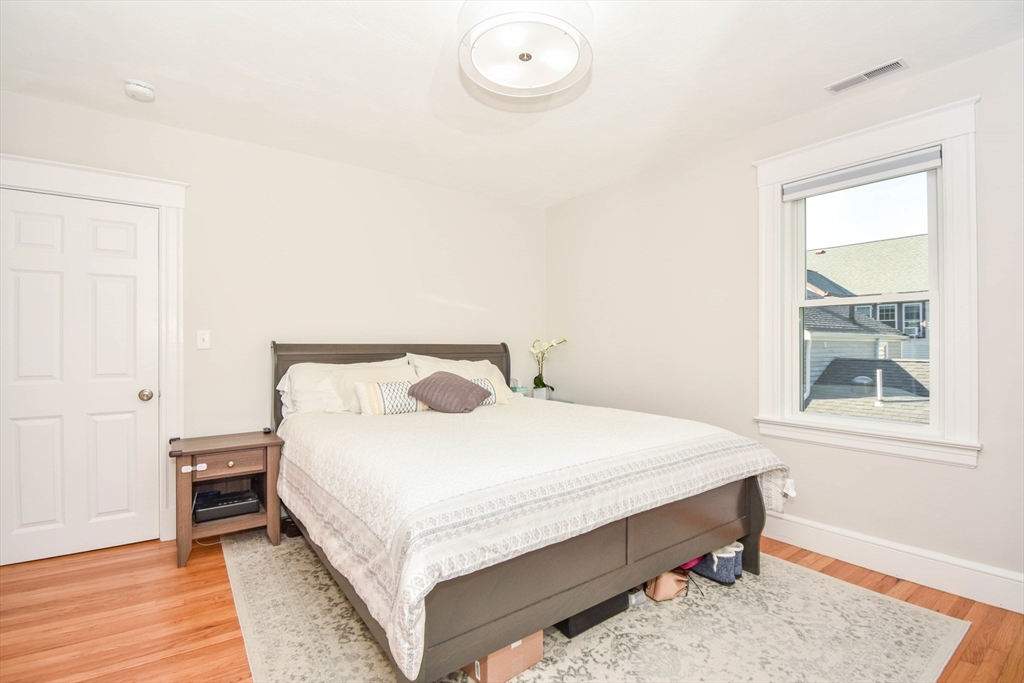 72 Evans Street, Unit 72 Watertown, MA 02472 - Photo 18 of 34 a bedroom with a bed and a window