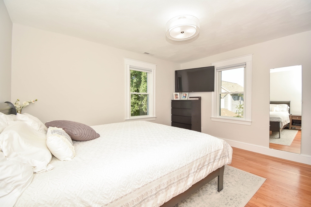 72 Evans Street, Unit 72 Watertown, MA 02472 - Photo 19 of 34 a bedroom with a bed and a flat screen tv