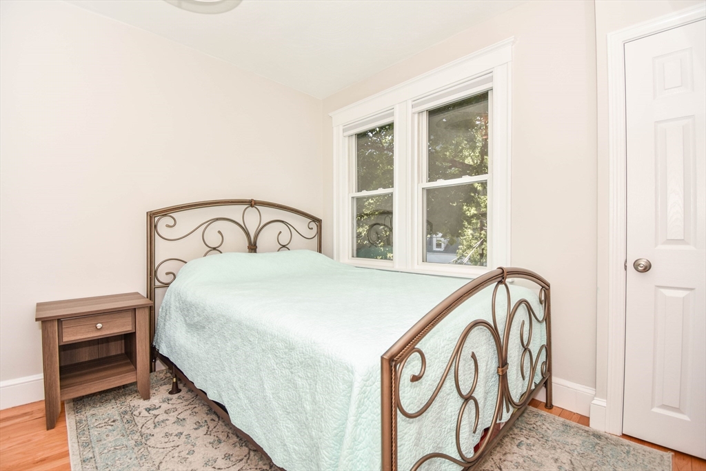 72 Evans Street, Unit 72 Watertown, MA 02472 - Photo 22 of 34 a bedroom with a bed and a window