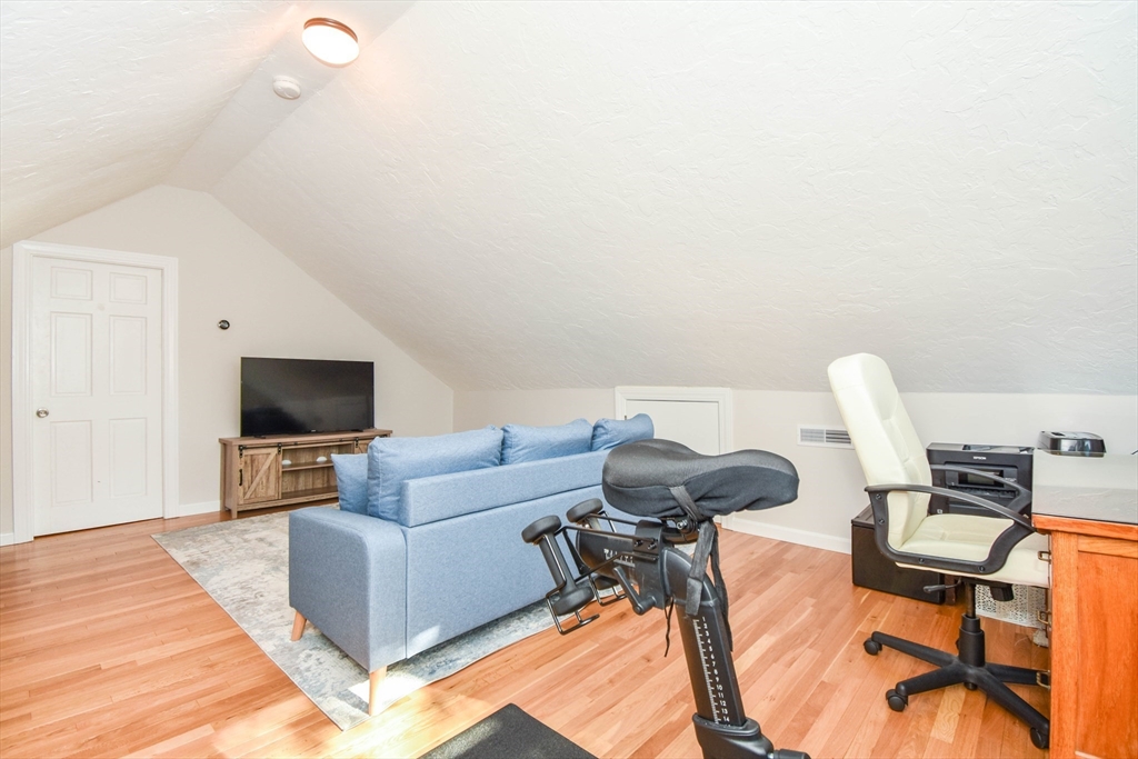 72 Evans Street, Unit 72 Watertown, MA 02472 - Photo 23 of 34 a living room with furniture and a flat screen tv