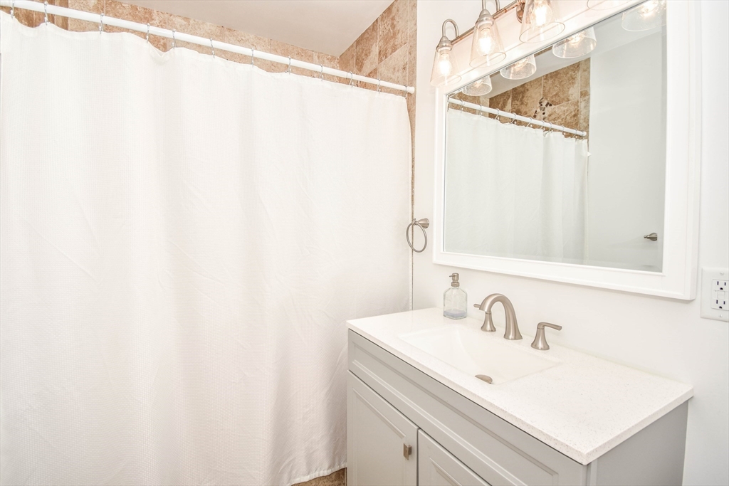 72 Evans Street, Unit 72 Watertown, MA 02472 - Photo 25 of 34 a bathroom with a sink and a mirror