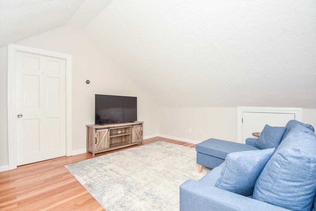 72 Evans Street, Unit 72 Watertown, MA 02472 - Photo 28 of 34 a living room with furniture and a flat screen tv