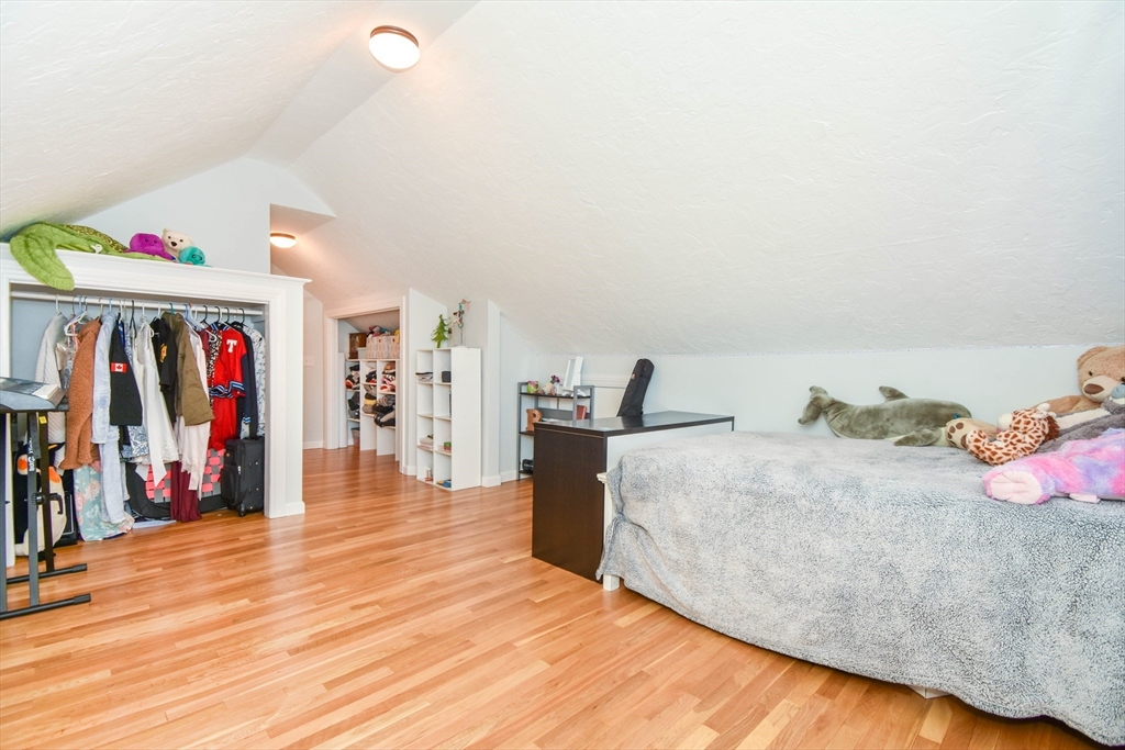 72 Evans Street, Unit 72 Watertown, MA 02472 - Photo 30 of 34 a spacious bedroom with a bed and a large mirror