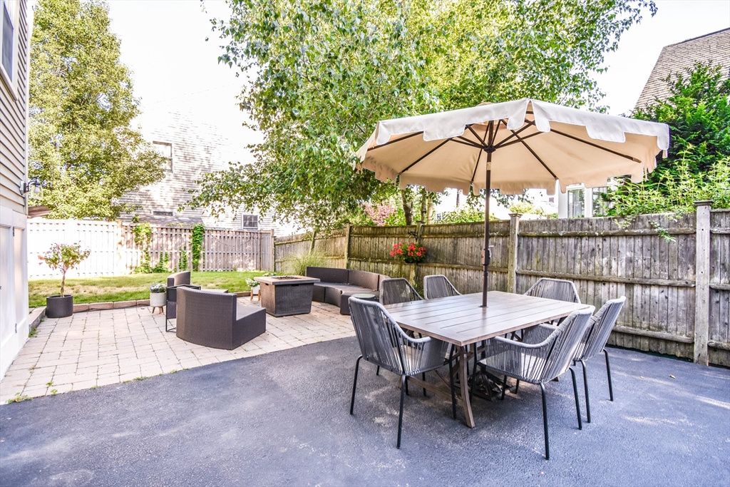 72 Evans Street, Unit 72 Watertown, MA 02472 - Photo 32 of 34 a view of a tables and chairs under an umbrella