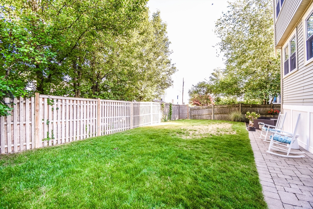 72 Evans Street, Unit 72 Watertown, MA 02472 - Photo 33 of 34 a view of a backyard with a garden
