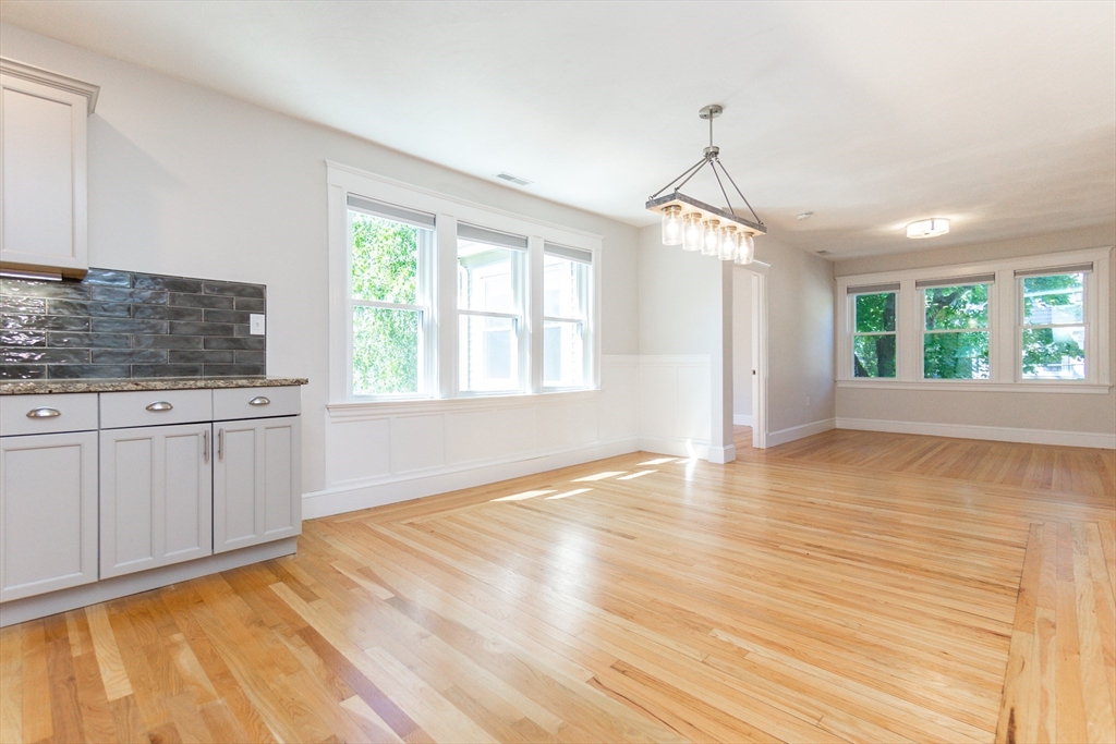 72 Evans Street, Unit 72 Watertown, MA 02472 - Photo 7 of 34 a view of an empty room with window and wooden floor