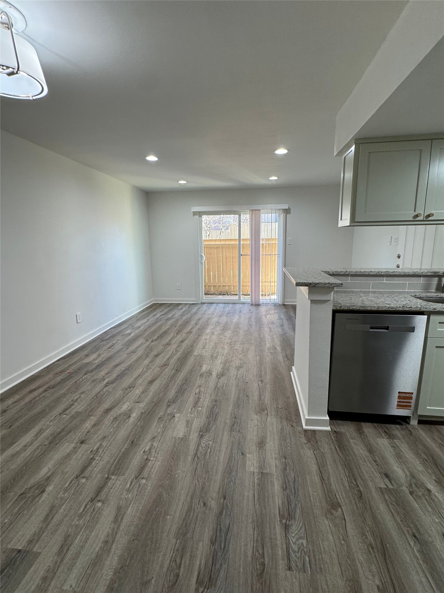 4747 Allendale Road, Unit 49 Houston, TX 77017 - Photo 7 of 8 an empty room with wooden floor and fireplace