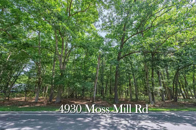a sign board with a park on the side of the road