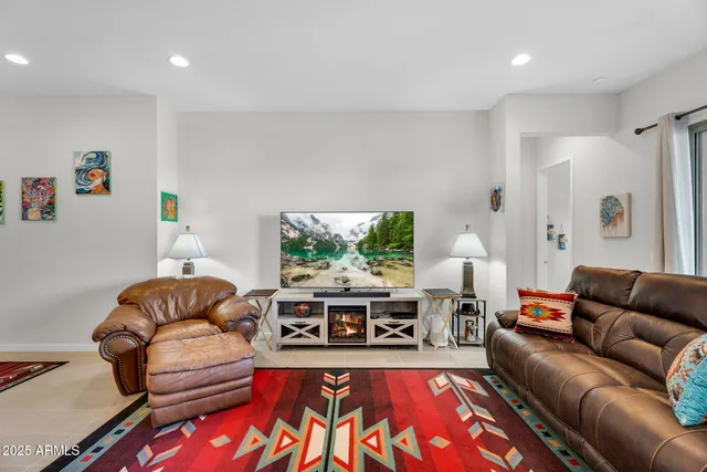 a living room with furniture kitchen view and a table