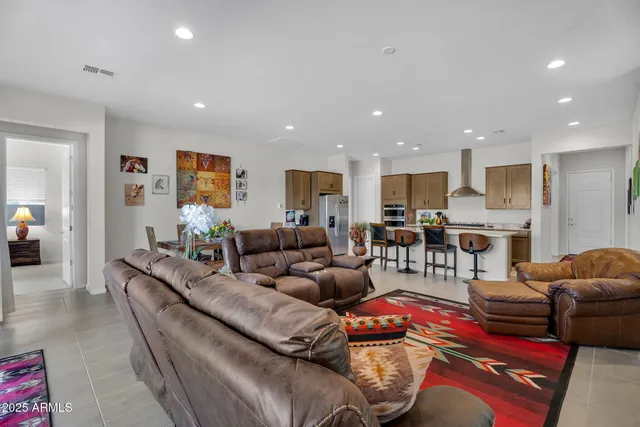 a living room with lots of furniture and kitchen view