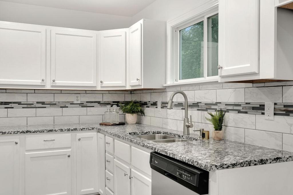 3714 Keck Place Gary, IN 46408 - Photo 12 of 24 a kitchen with granite countertop white cabinets and a sink