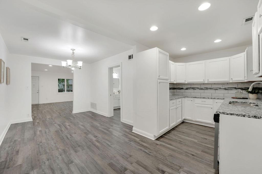 3714 Keck Place Gary, IN 46408 - Photo 10 of 24 a kitchen with a refrigerator and white cabinets