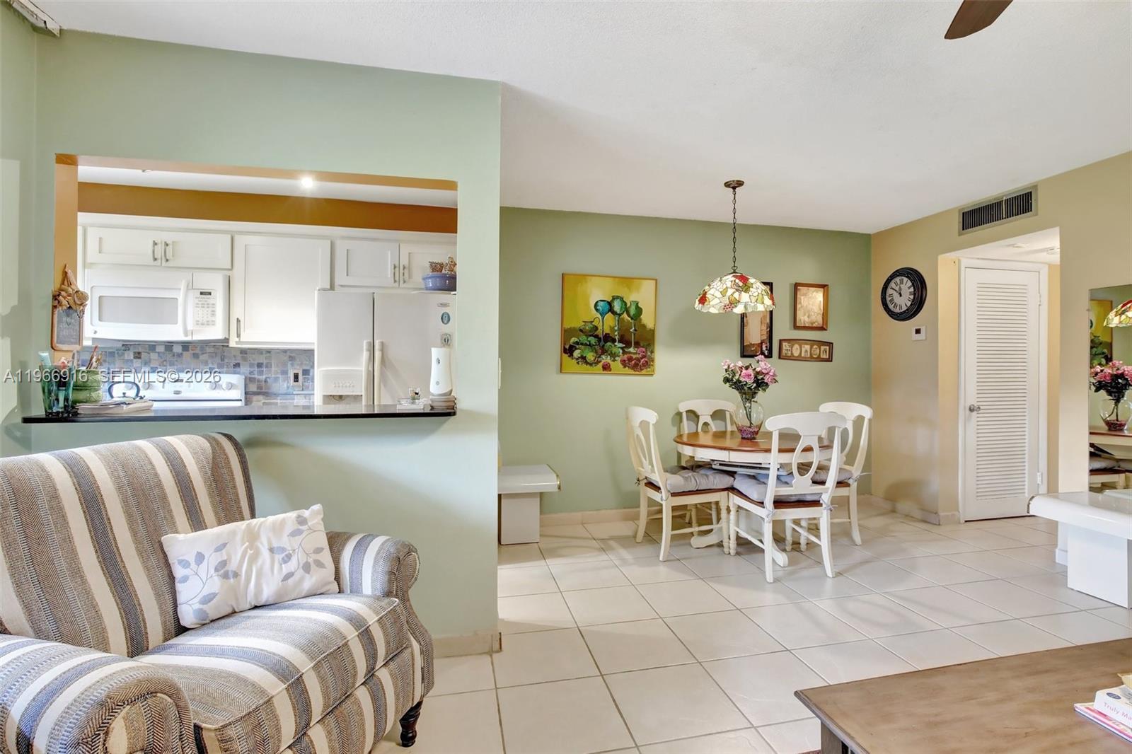 5300 Washington Street, Unit G127 Hollywood, FL 33021 - Photo 11 of 39 a living room with furniture and a dining table