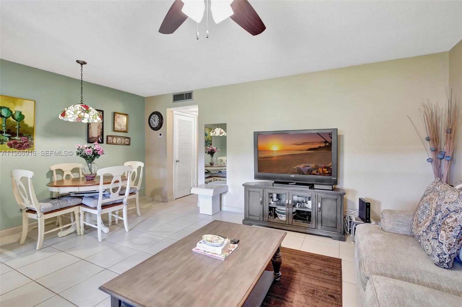 5300 Washington Street, Unit G127 Hollywood, FL 33021 - Photo 12 of 39 a living room with furniture and a flat screen tv
