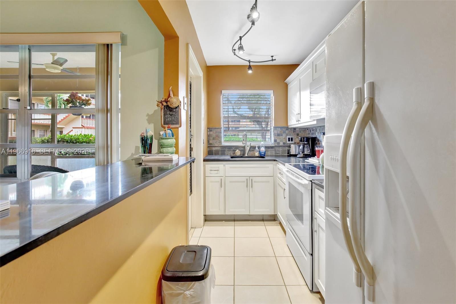 5300 Washington Street, Unit G127 Hollywood, FL 33021 - Photo 15 of 39 a kitchen with a sink a counter top space and stainless steel appliances