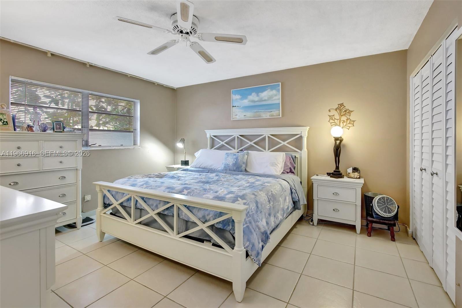 5300 Washington Street, Unit G127 Hollywood, FL 33021 - Photo 17 of 39 a bedroom with a bed and a chandelier