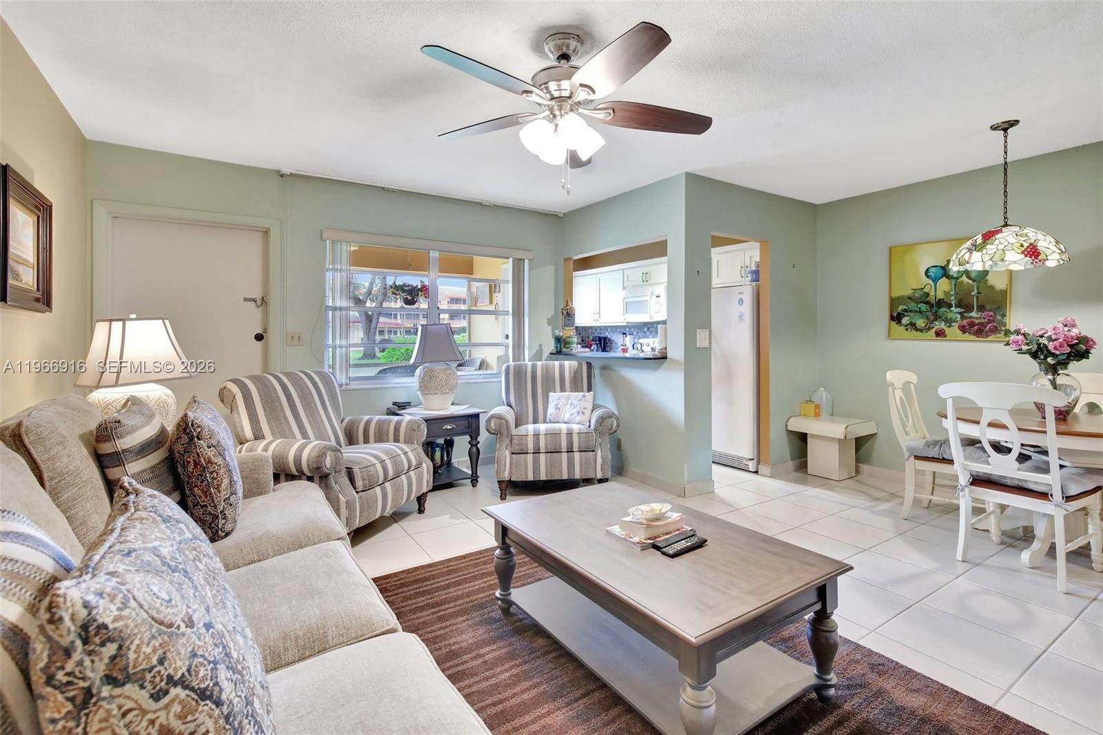 5300 Washington Street, Unit G127 Hollywood, FL 33021 - Photo 10 of 39 a living room with furniture and a large window