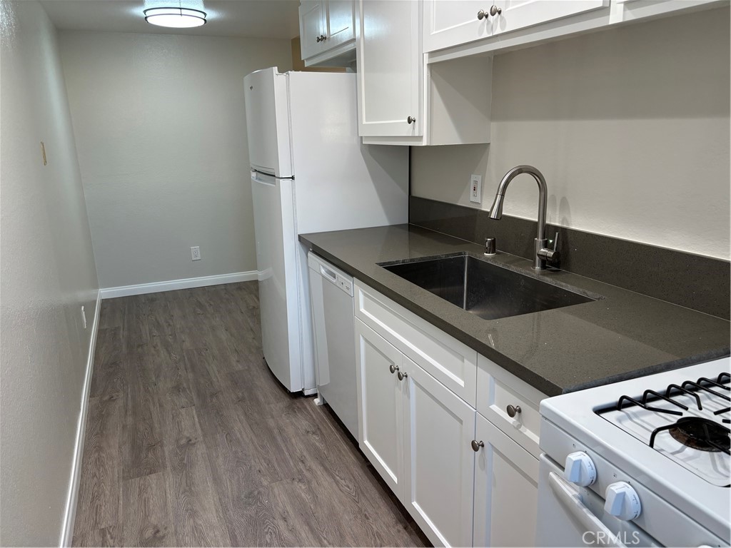 a kitchen with a sink and a refrigerator