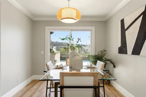 a view of a dining room with furniture and wooden floor