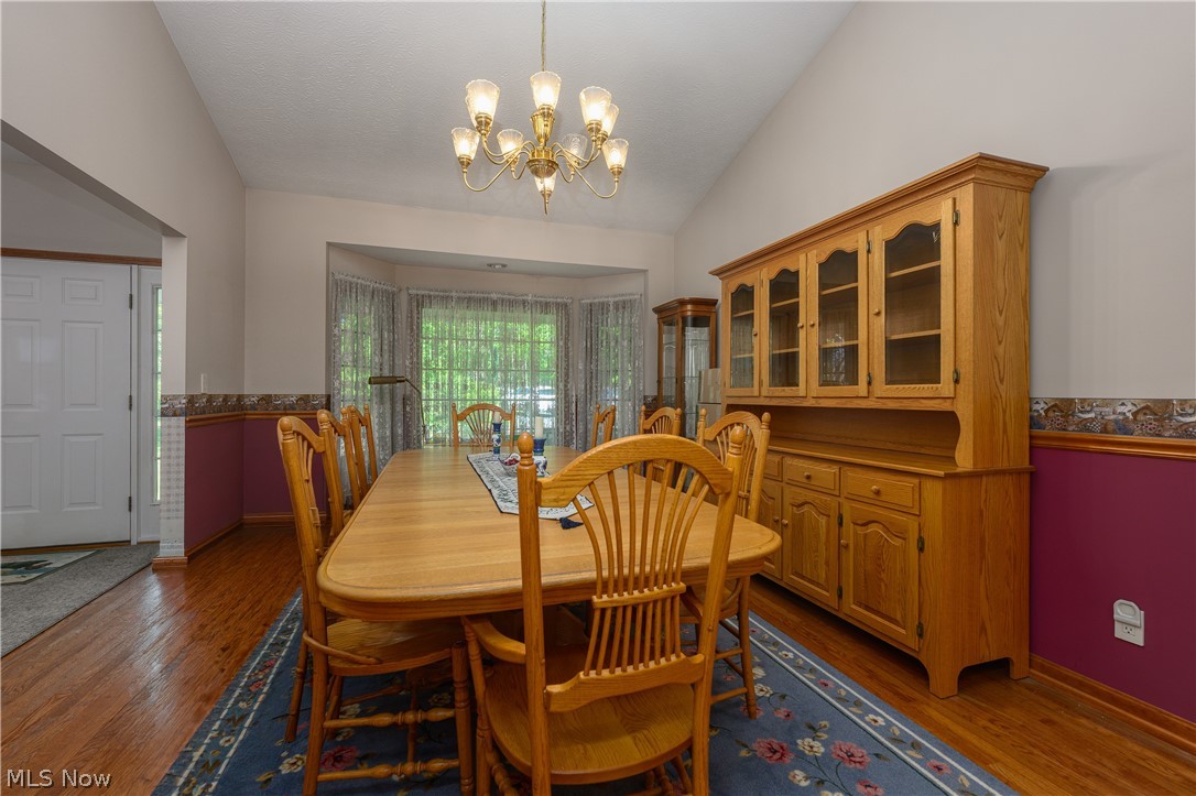 8745 Broadview Road Broadview Heights, OH 44147 - Photo 9 of 49 Dining space featuring wood-finish flooring, a bay window, and a vaulted ceiling