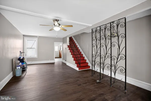 a kitchen with a refrigerator a sink cabinets and wooden floor