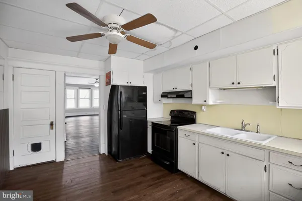 a kitchen with stainless steel appliances granite countertop a stove a refrigerator and a sink