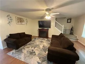 a living room with furniture and a flat screen tv