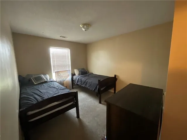 a bedroom with two beds and a window