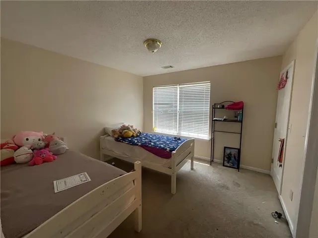 a bedroom with furniture and a window