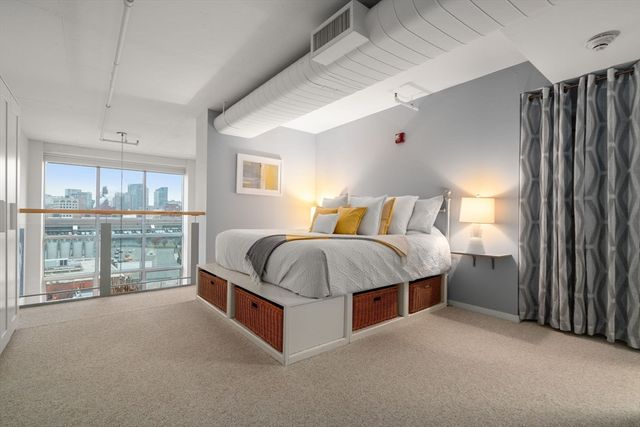 a bedroom with a bed and a potted plant