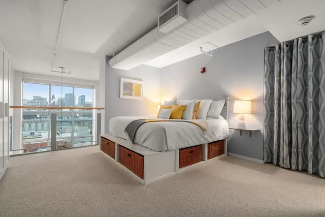 a bedroom with a bed and a potted plant