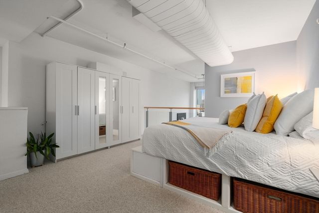 a bed sitting in a bedroom next to a bathroom