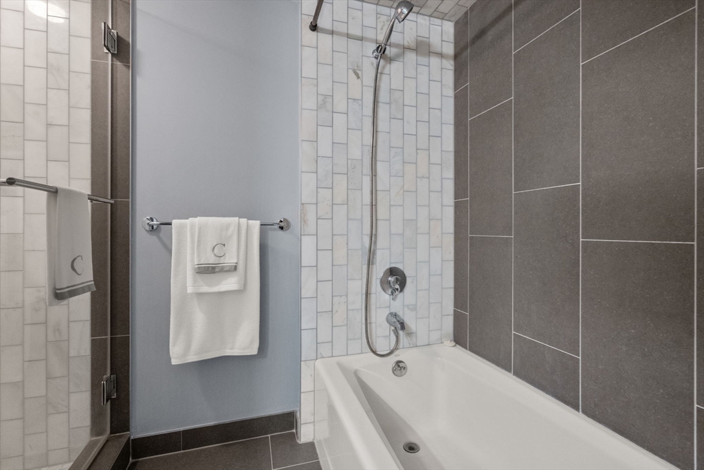 25 Channel Center Street, Unit 807 Boston, MA 02210 - Photo 20 of 27 a bathroom with a bathtub and shower