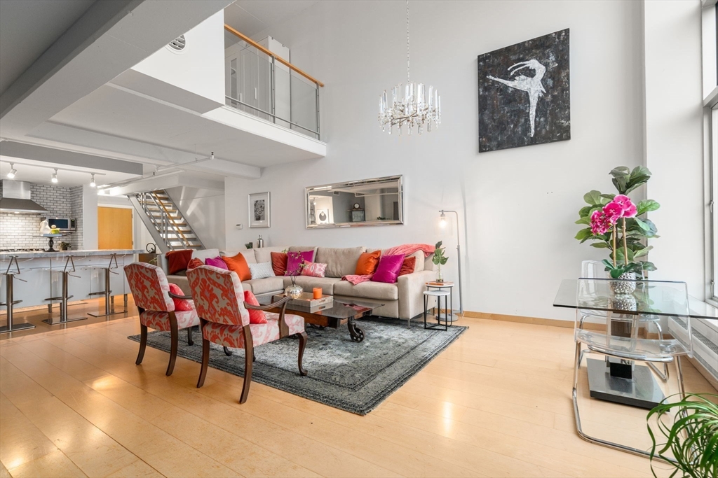 25 Channel Center Street, Unit 807 Boston, MA 02210 - Photo 4 of 27 a living room with furniture and flowers