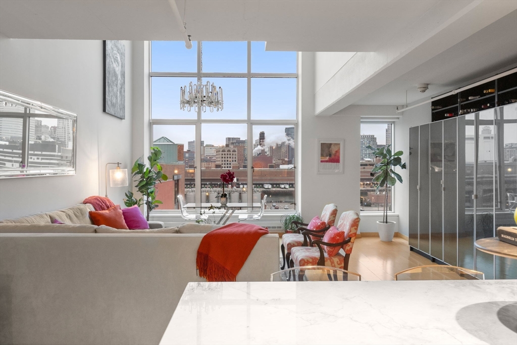 25 Channel Center Street, Unit 807 Boston, MA 02210 - Photo 9 of 27 a living room filled with furniture and a large window