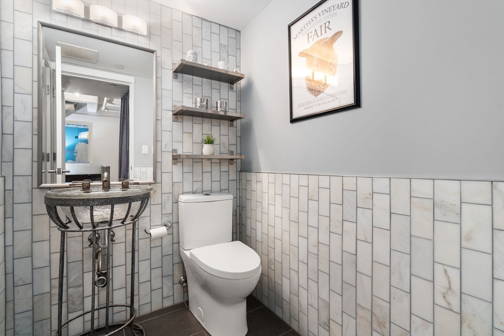 25 Channel Center Street, Unit 807 Boston, MA 02210 - Photo 10 of 27 a bathroom with a toilet a sink and mirror