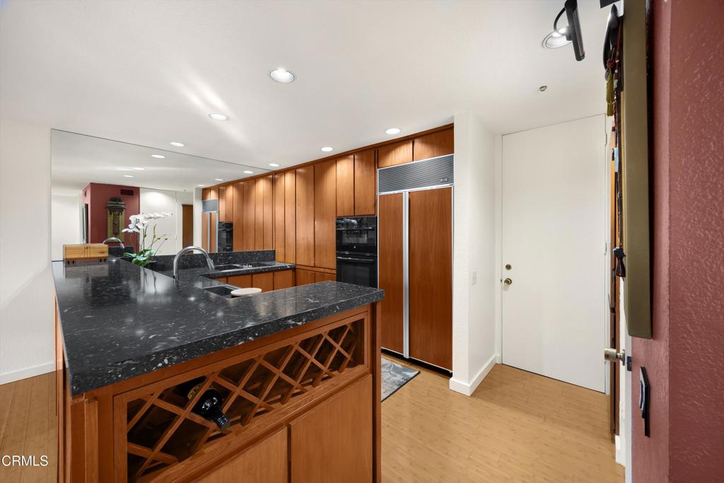 200 Arroyo Terrace Pasadena, CA 91103 - Photo 15 of 66 a kitchen with stainless steel appliances granite countertop a sink a stove and a refrigerator