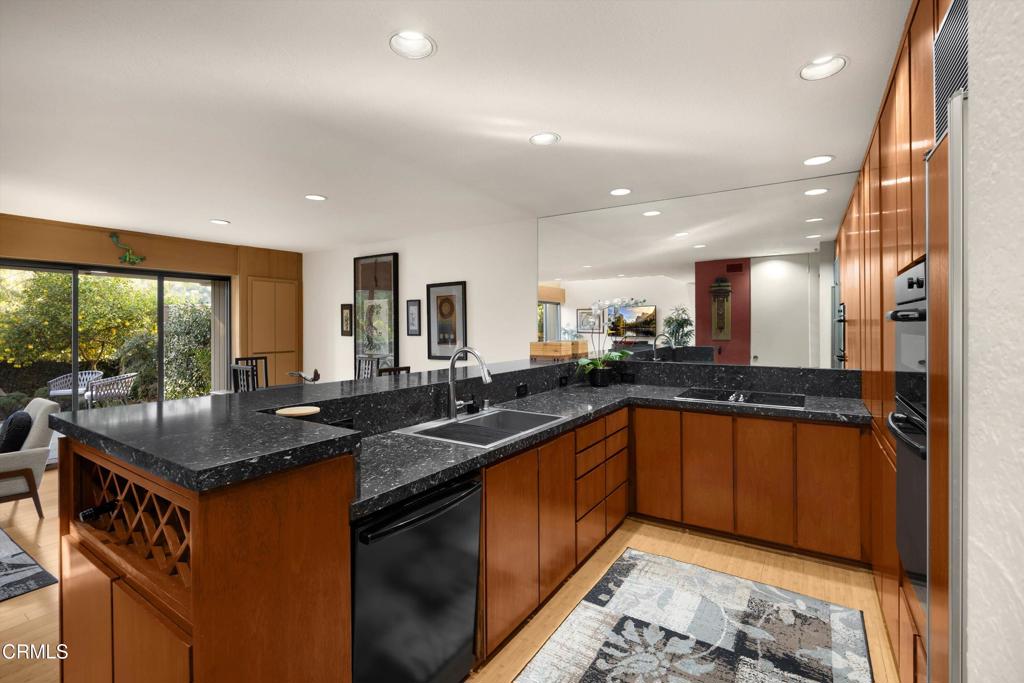 200 Arroyo Terrace Pasadena, CA 91103 - Photo 17 of 66 a kitchen with stainless steel appliances granite countertop sink stove and large window