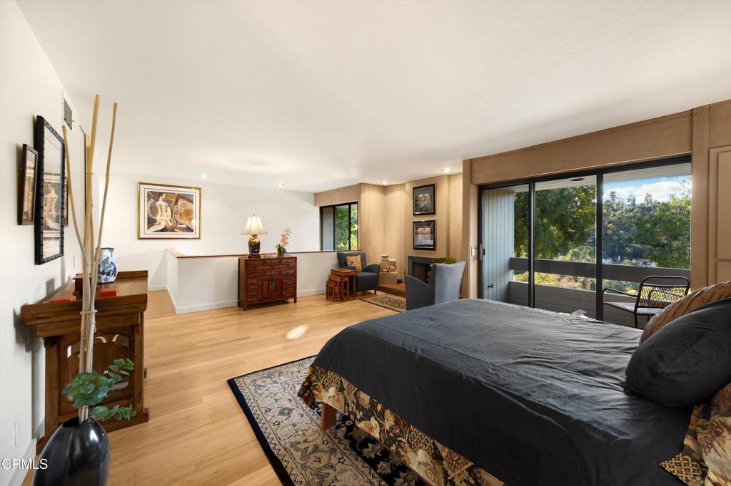 200 Arroyo Terrace Pasadena, CA 91103 - Photo 24 of 66 a large bedroom with a bed and wooden floor