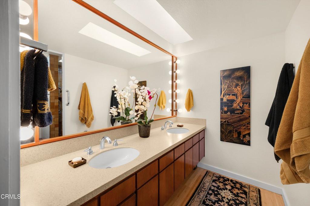 200 Arroyo Terrace Pasadena, CA 91103 - Photo 28 of 66 a bathroom with a double vanity sink and a mirror