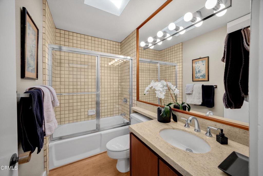 200 Arroyo Terrace Pasadena, CA 91103 - Photo 33 of 66 a bathroom with a granite countertop sink a toilet a mirror and shower
