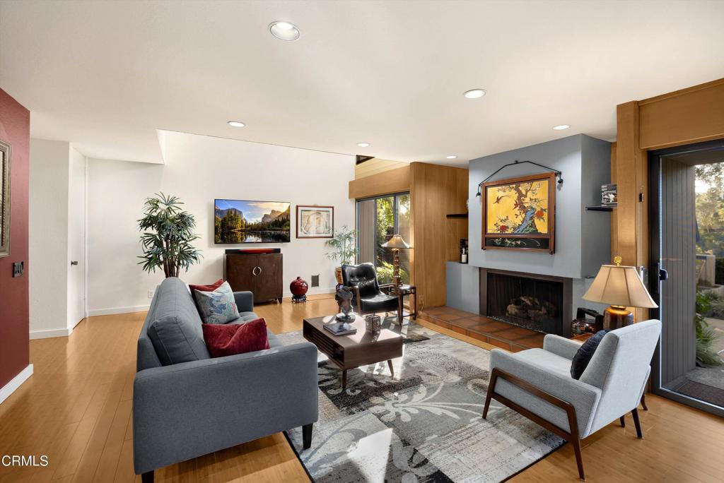 200 Arroyo Terrace Pasadena, CA 91103 - Photo 8 of 66 a living room with furniture a fireplace and a flat screen tv