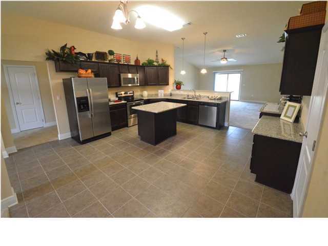 5617 Price Plantation Road Baker, FL 32531 - Photo 4 of 13 a kitchen with kitchen island a sink a counter top space and stainless steel appliances