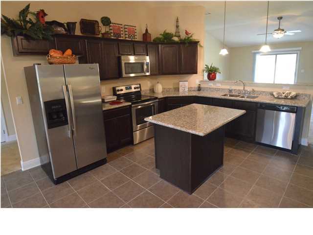 5617 Price Plantation Road Baker, FL 32531 - Photo 6 of 13 a kitchen with stainless steel appliances granite countertop a sink stove and refrigerator