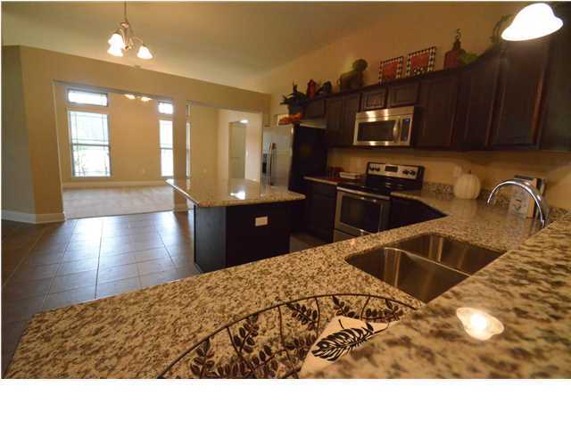 5617 Price Plantation Road Baker, FL 32531 - Photo 7 of 13 a kitchen with stainless steel appliances kitchen island granite countertop a sink refrigerator and cabinets