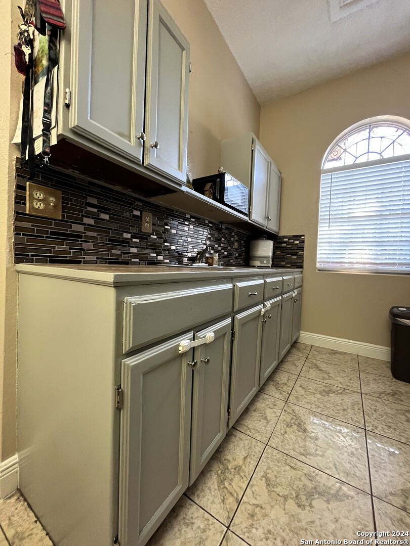 155 Lynn Loop Laredo, TX 78045 - Photo 7 of 17 a kitchen with stainless steel appliances granite countertop a stove a sink and a microwave