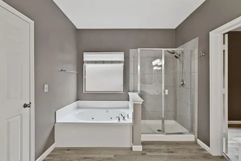 a bathroom with a bathtub and a shower