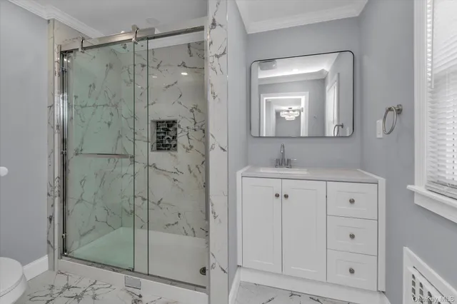 a bathroom with a shower a sink and mirror